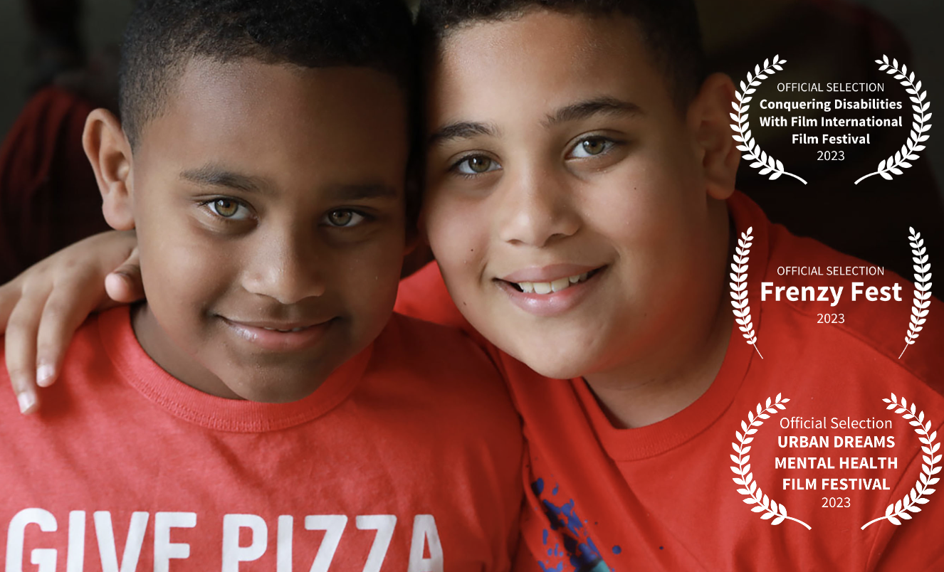 2 boys with red shirts looking in to the lens. 3 Festival Laurels on right side. AUTISM: THE LIFE BEHIND THE WORD
