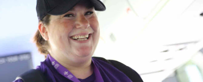 woman with vitiligo wearing purple and smiling