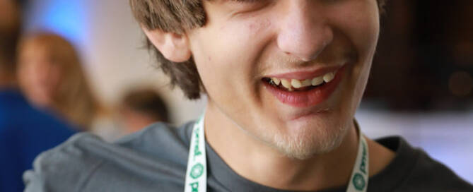 boy with Phelan-McDermid Syndrome smiling and looking to the right