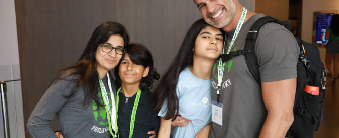 girl with Phelan-McDermid Syndrome stands with her brother, mother, and father for photograph