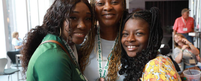 girl with Phelan-McDermid Syndrome standing next to two other women, all smiling