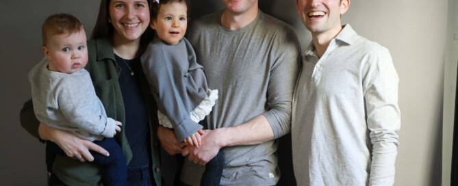 young girl with chromosome 5p- (Cri Du Chat) being held by her father, full family photo