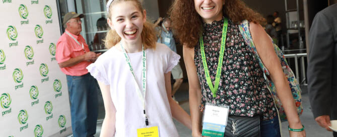 young girl with Phelan-McDermid Syndrome holding hands with her mom and walking towards the camera