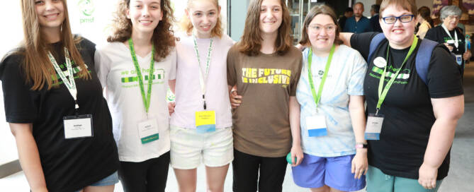 group of girls with Phelan-McDermid Syndrome all stand together and smile for a photo