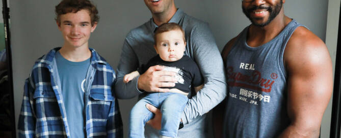 one young boy, two men, and a toddler boy all with xxy syndrome pose together for a photo