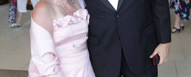 girl with turner syndrome wearing pink dress next to man in tuxedo